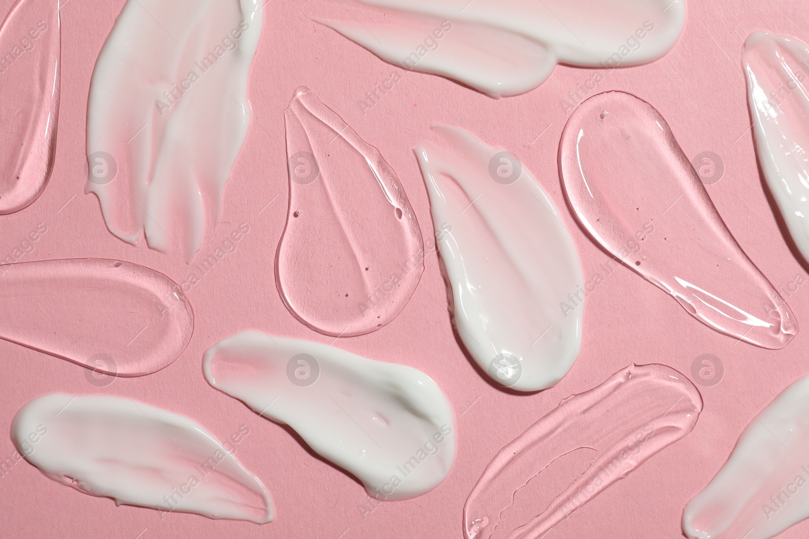 Photo of Body cream and gel on pink background, flat lay