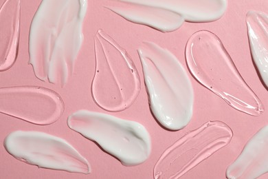 Photo of Body cream and gel on pink background, flat lay