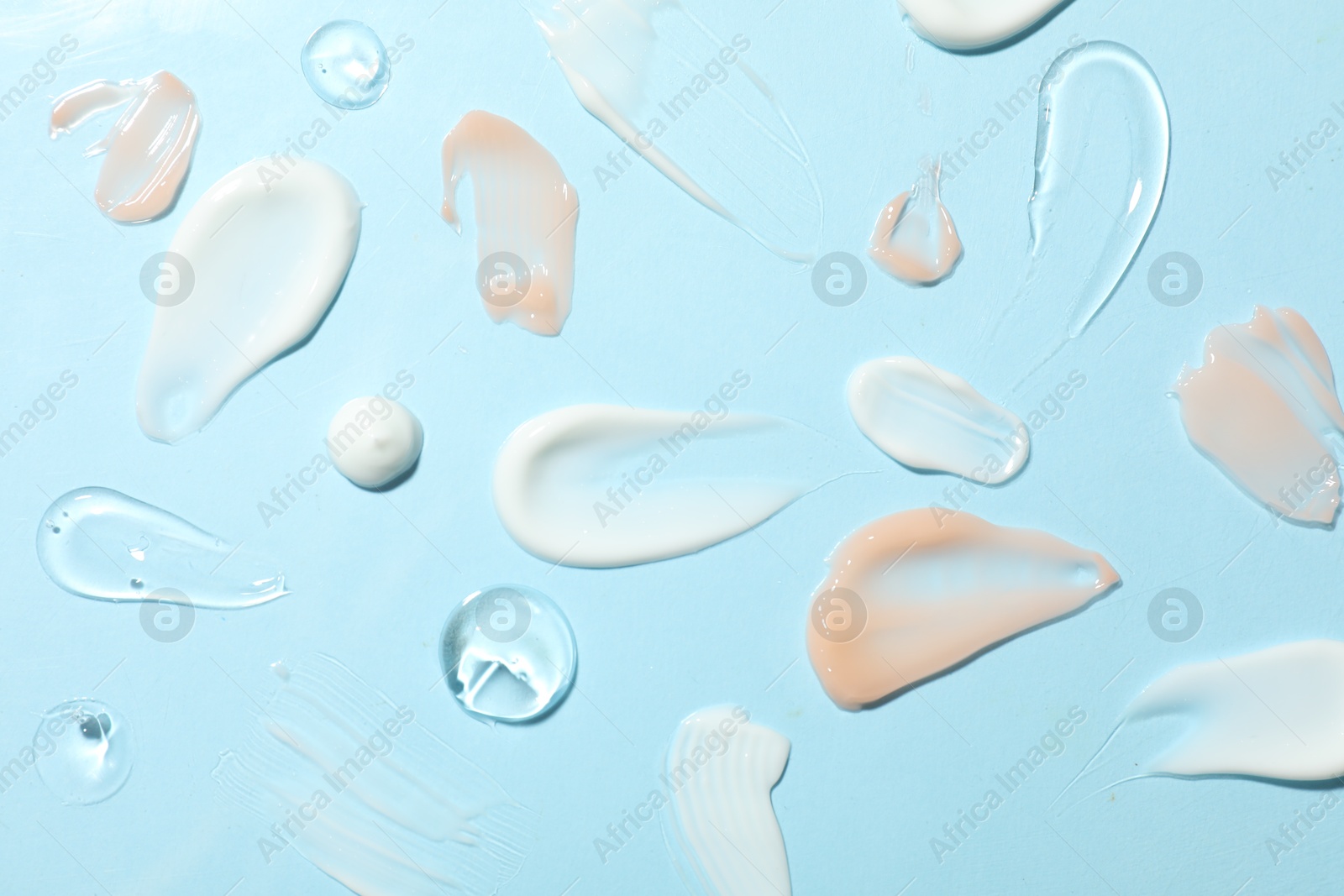 Photo of Different cosmetic products on light blue background, flat lay