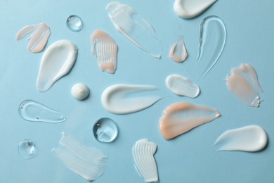 Photo of Different cosmetic products on light blue background, flat lay