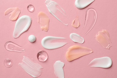 Photo of Different cosmetic products on pink background, flat lay