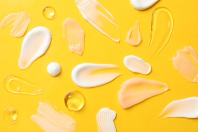 Photo of Different cosmetic products on yellow background, flat lay