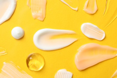 Photo of Different cosmetic products on yellow background, flat lay