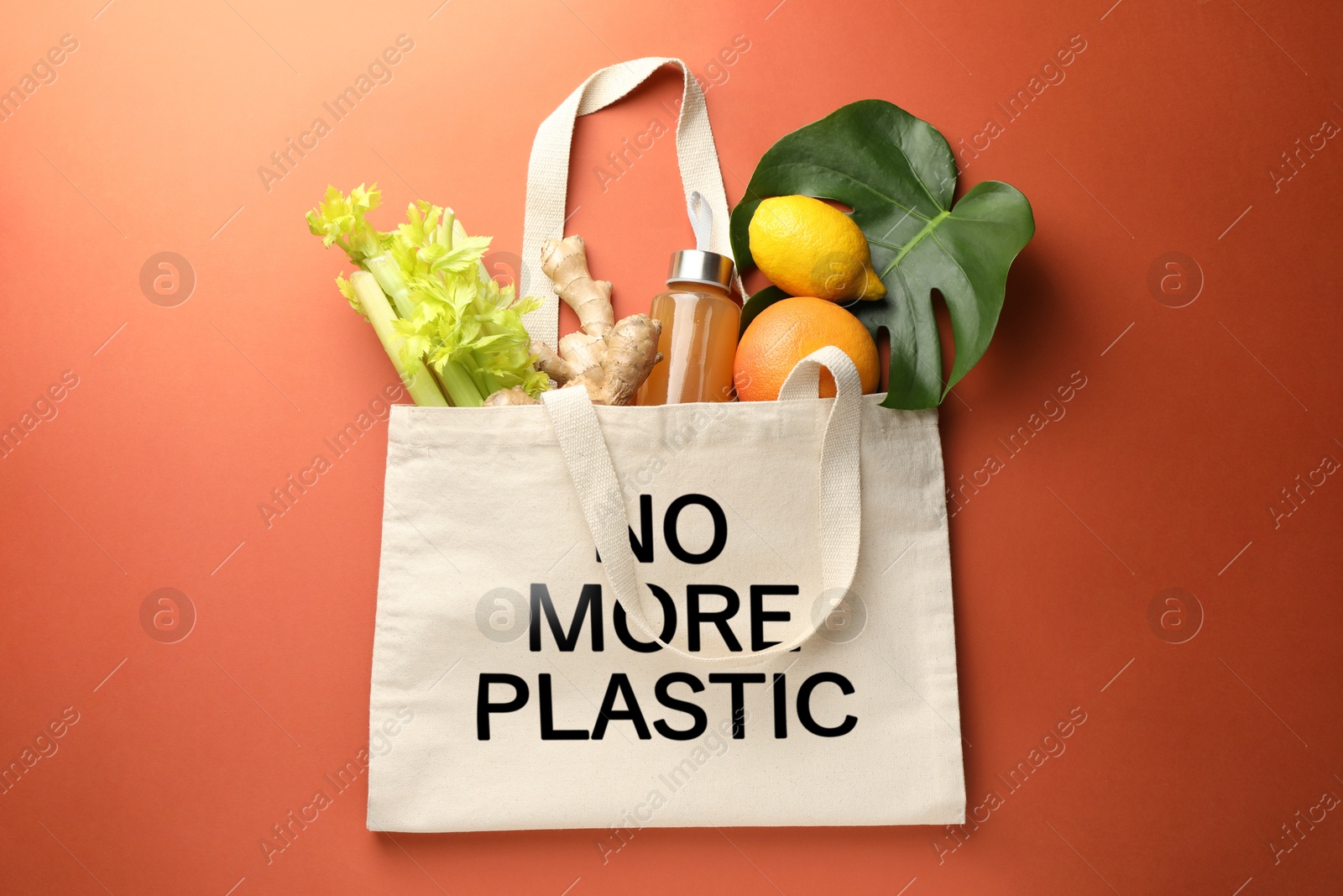 Image of Eco bag with No More Plastic text and products on orange background, top view