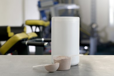 Image of Protein powder on grey table in gym