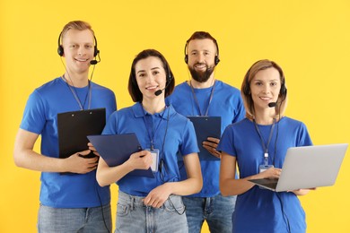 Technical support call center. Team of friendly operators on yellow background