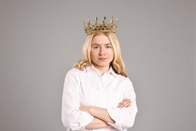 Photo of Woman in elegant crown with crossed arms on grey background