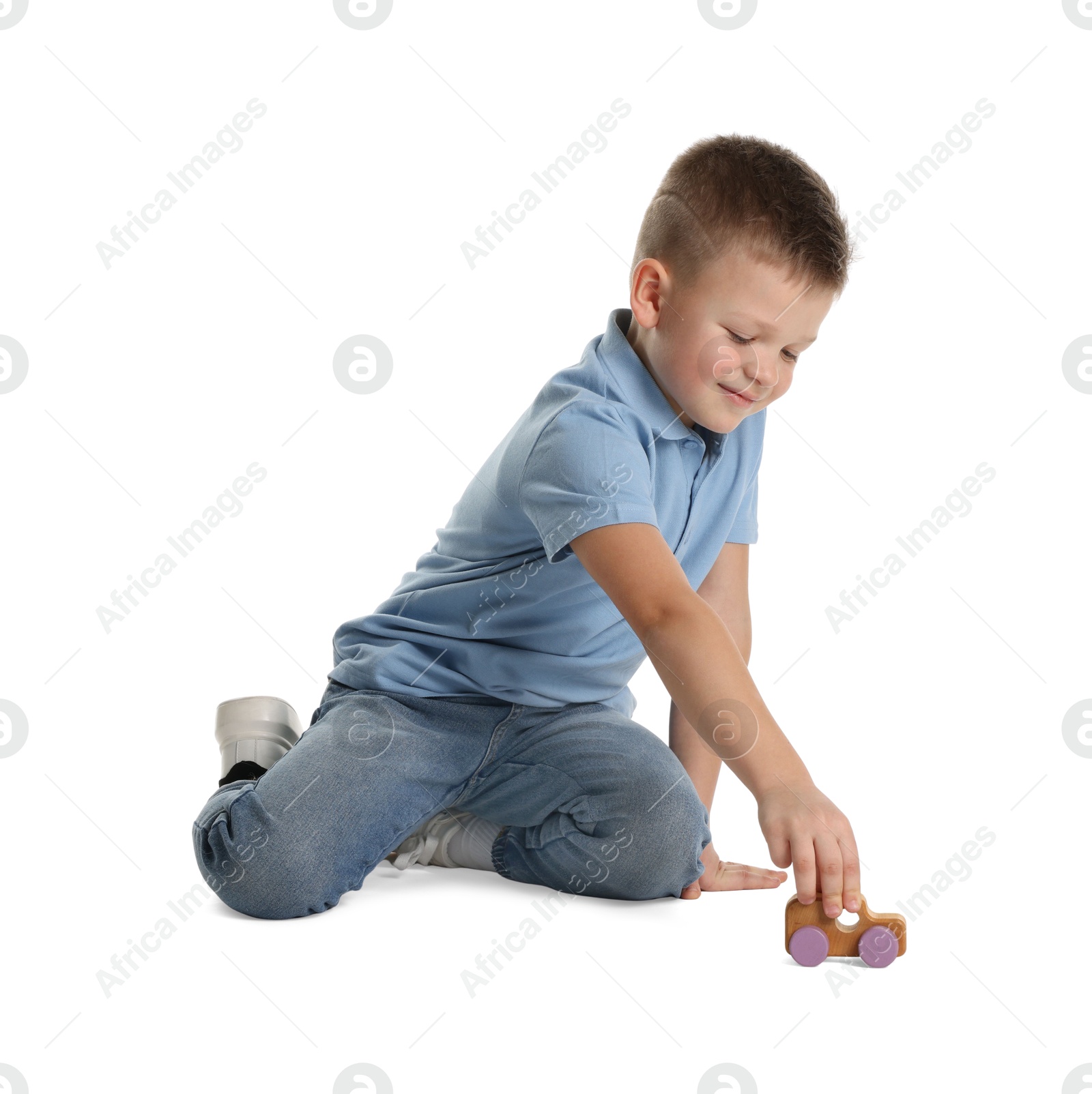 Photo of Little boy playing with toy car on white background