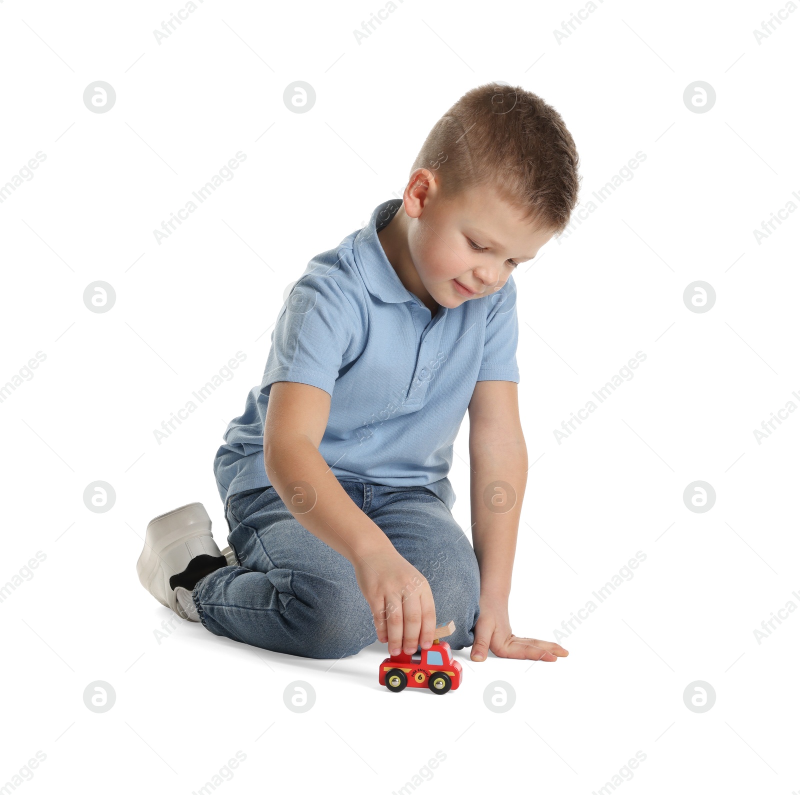 Photo of Little boy playing with toy car on white background