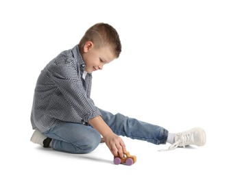 Photo of Little boy playing with toy car on white background