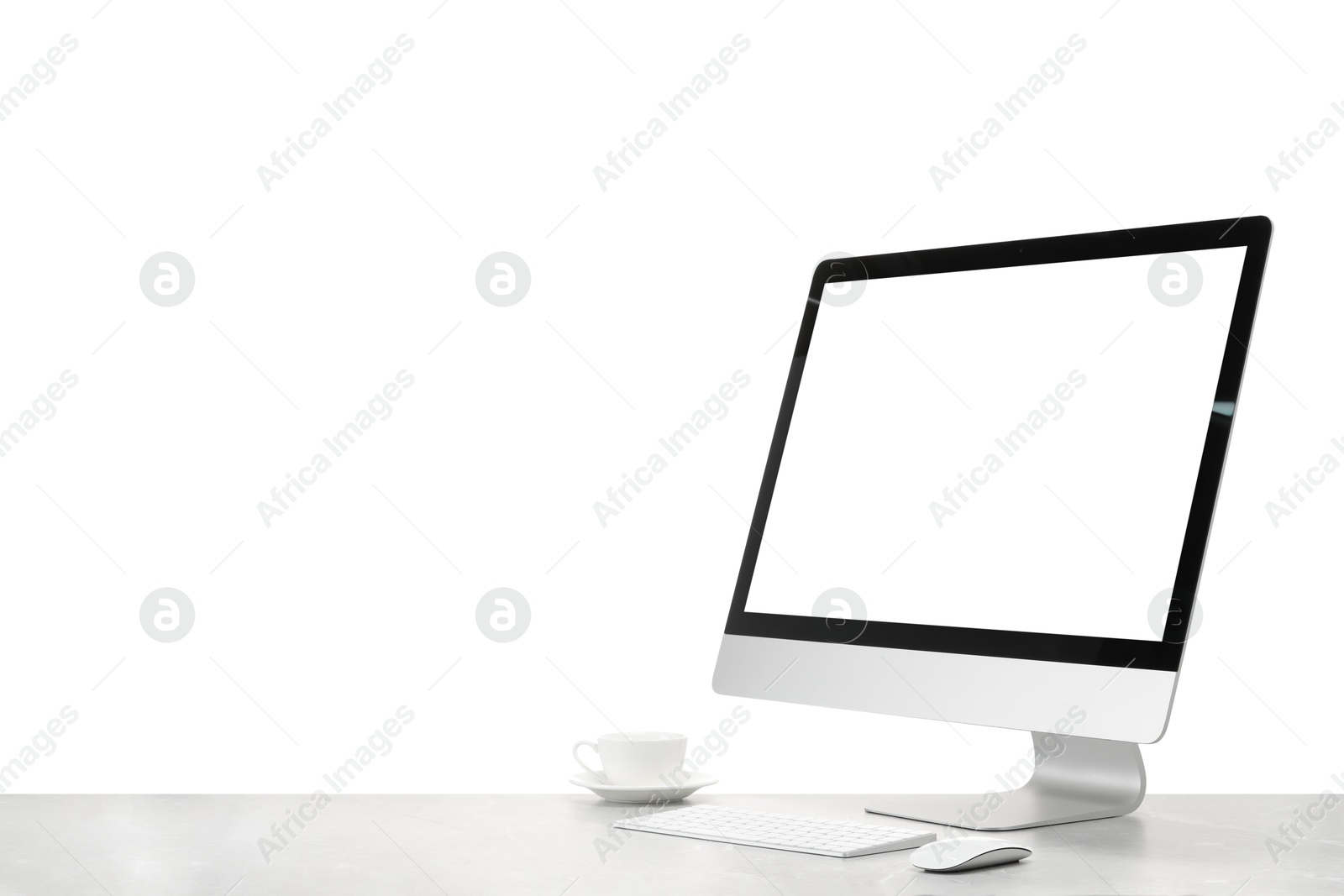 Photo of Computer monitor, keyboard, mouse and cup of drink on grey desk against white background