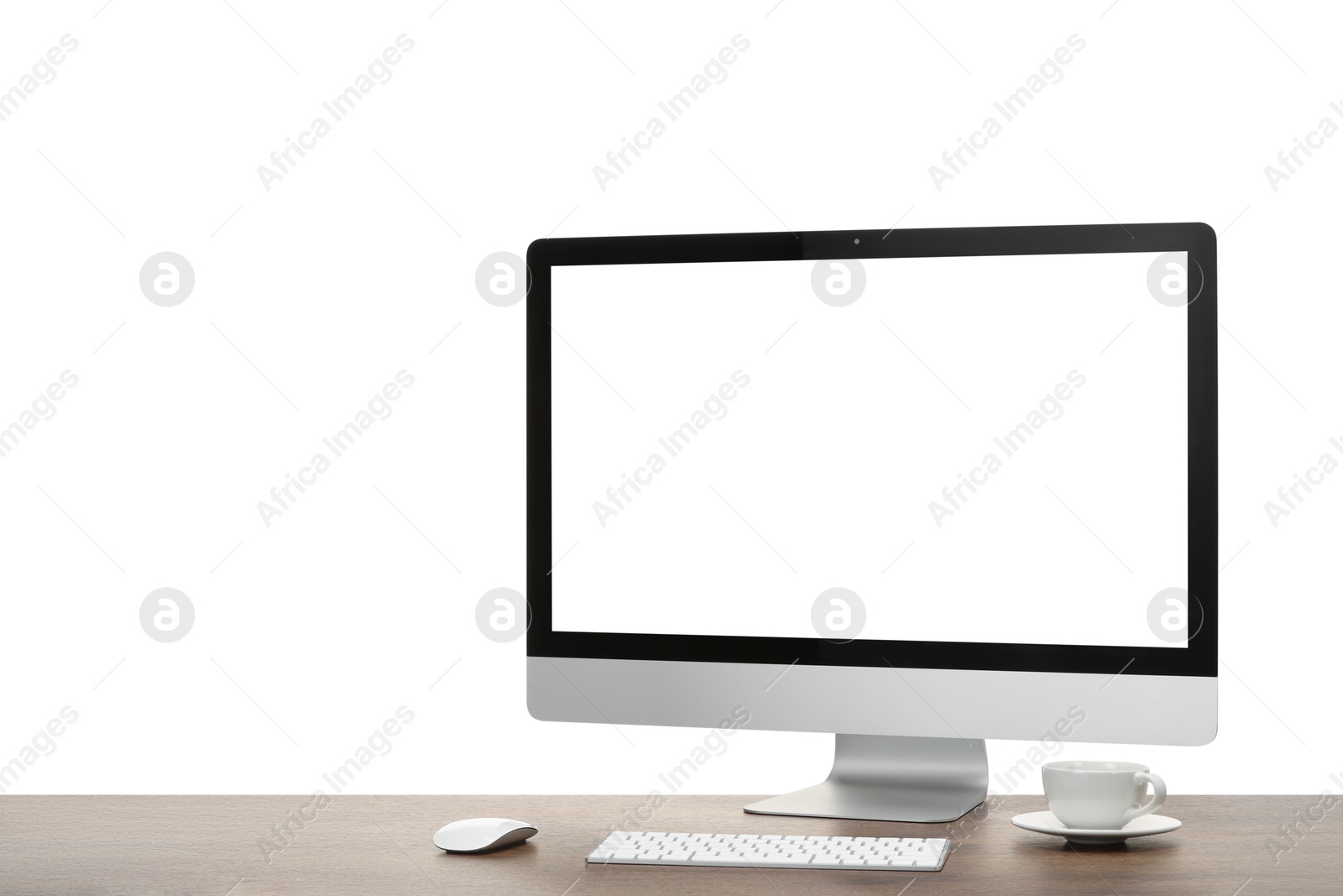 Photo of Computer monitor, keyboard, mouse and cup of drink on wooden desk against white background