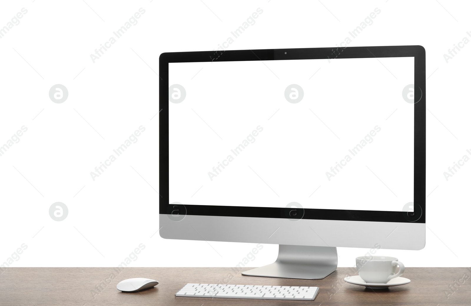 Photo of Computer monitor, keyboard, mouse and cup of drink on wooden desk against white background