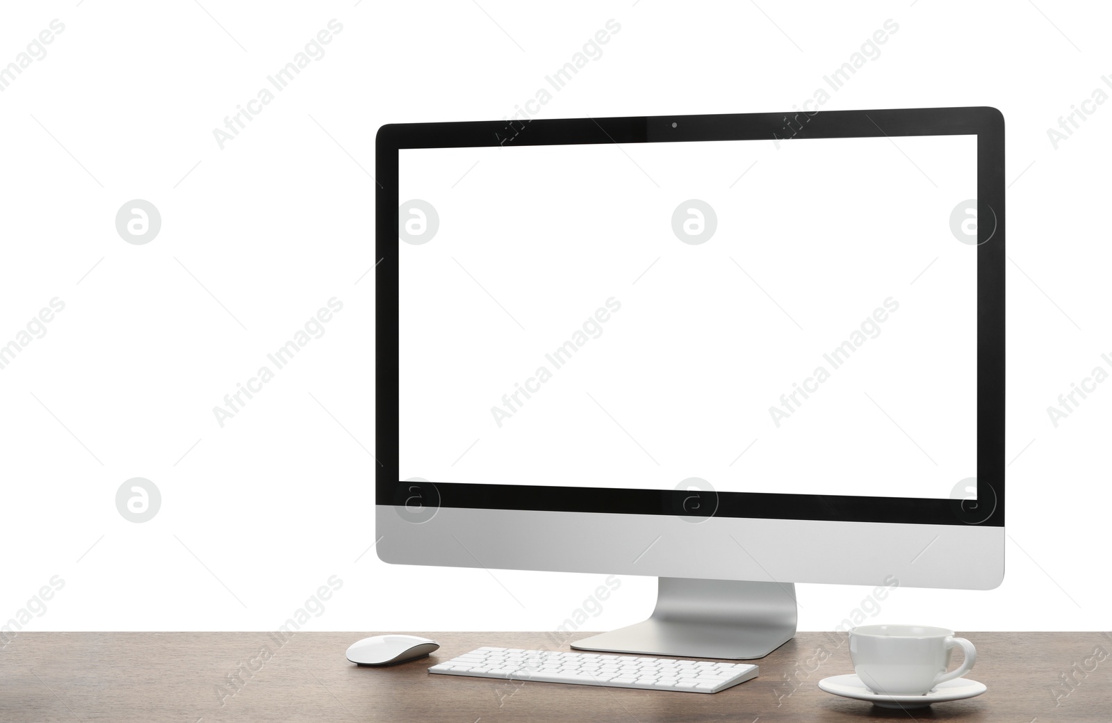 Photo of Computer monitor, keyboard, mouse and cup of drink on wooden desk against white background