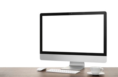 Photo of Computer monitor, keyboard, mouse and cup of drink on wooden desk against white background