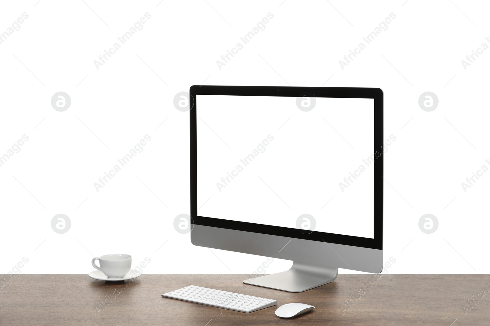 Photo of Computer monitor, keyboard, mouse and cup of drink on wooden desk against white background