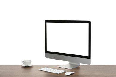 Photo of Computer monitor, keyboard, mouse and cup of drink on wooden desk against white background