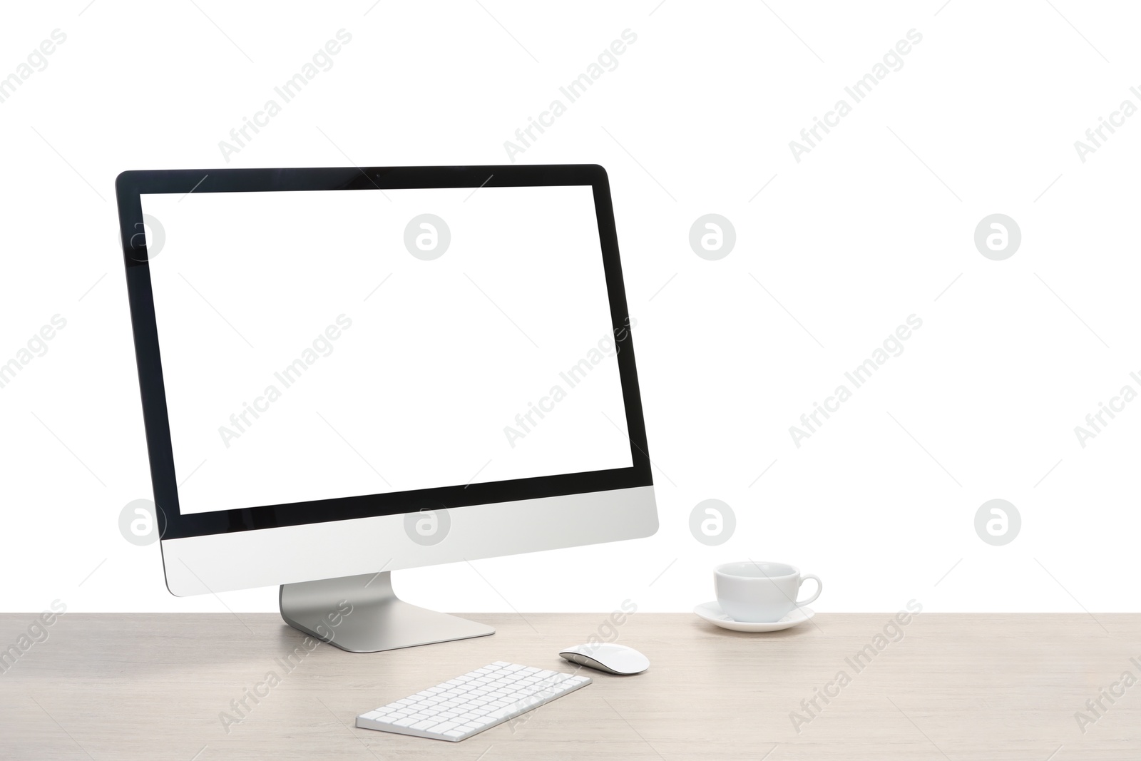 Photo of Computer monitor, keyboard, mouse and cup of drink on wooden desk against white background