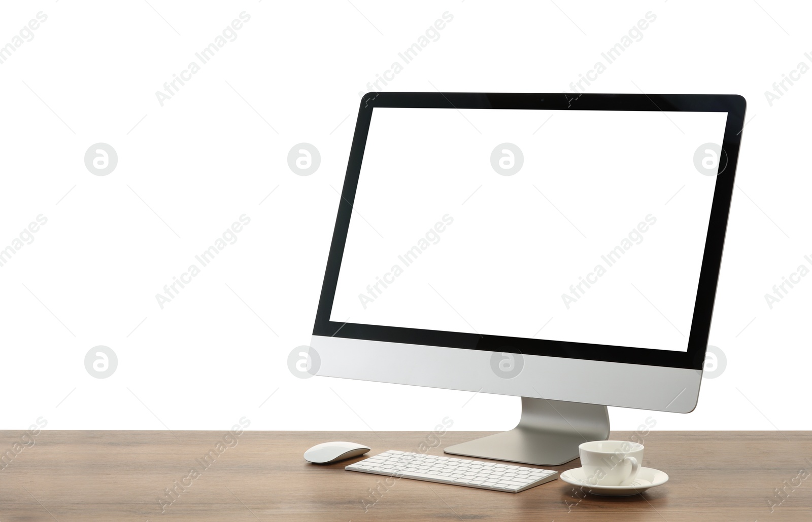 Photo of Computer monitor, keyboard, mouse and cup of drink on wooden desk against white background