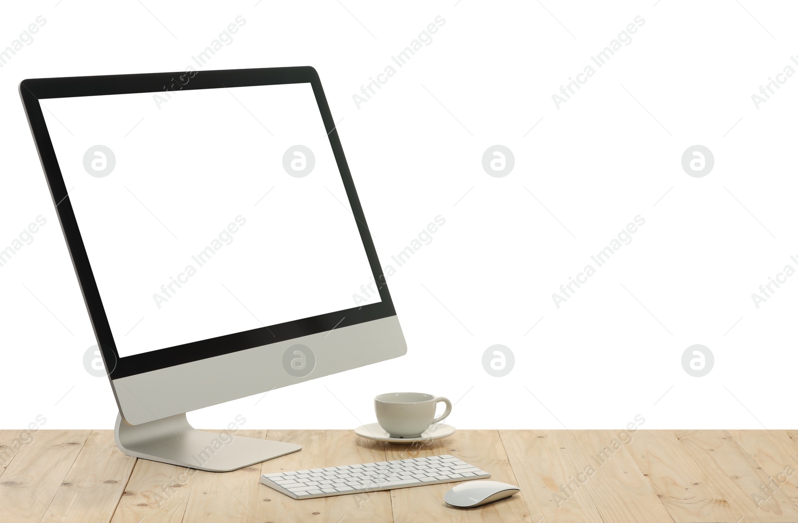 Photo of Computer monitor, keyboard, mouse and cup of drink on wooden desk against white background