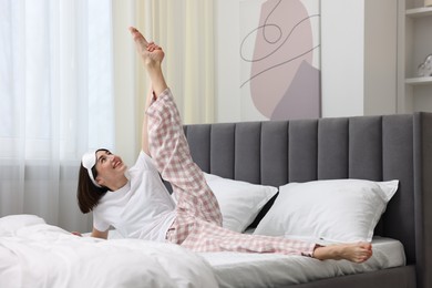 Photo of Young woman exercising on bed at home. Morning routine