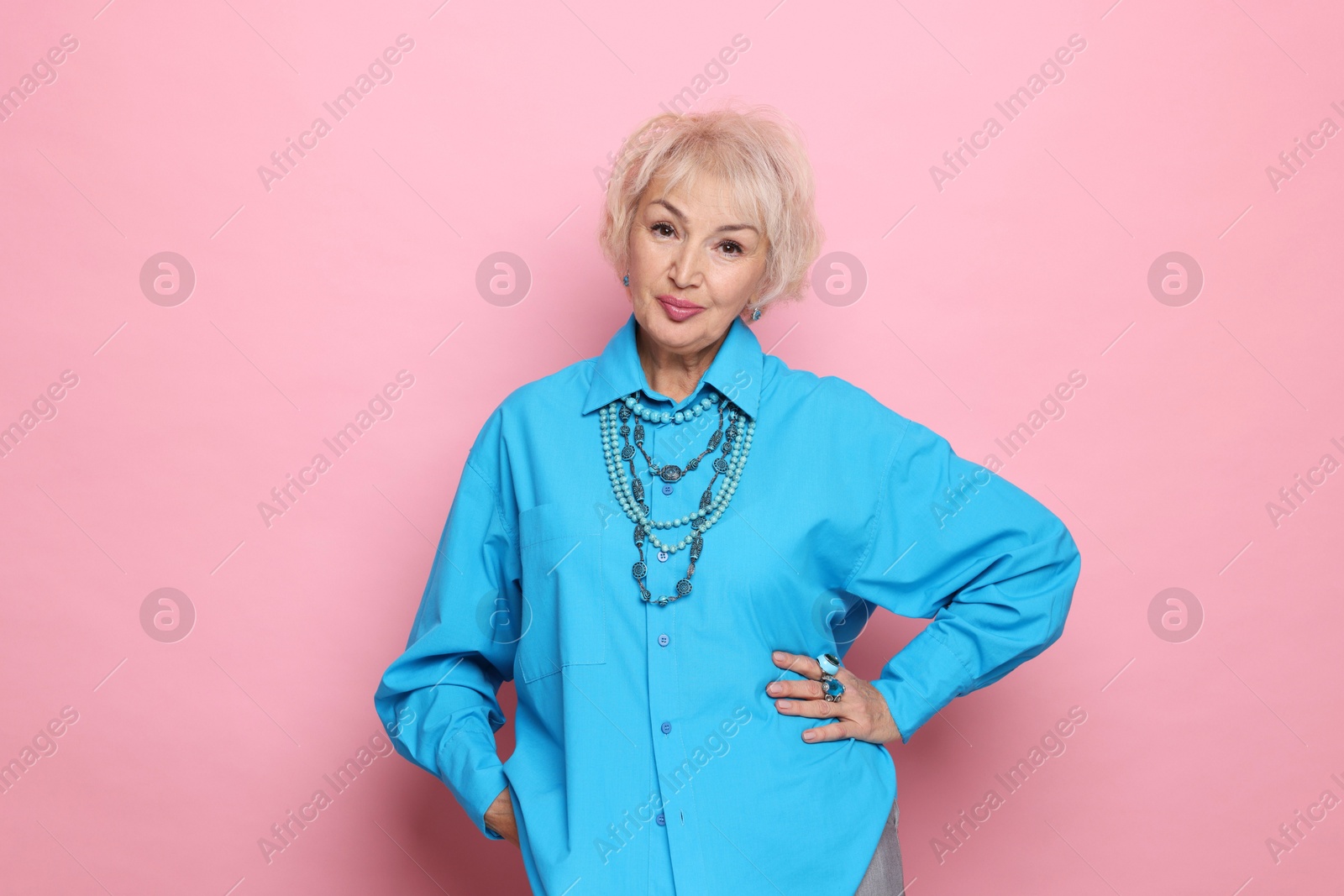 Photo of Portrait of elegant grandmother on pink background