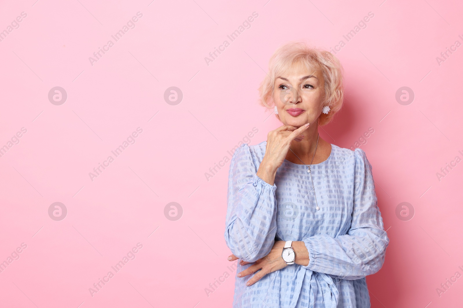 Photo of Portrait of elegant grandmother on pink background. Space for text