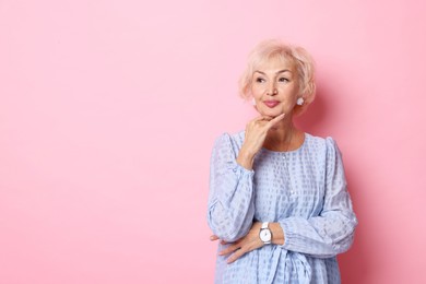 Photo of Portrait of elegant grandmother on pink background. Space for text