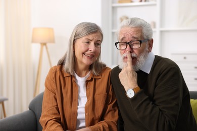 Cute elderly couple having fun at home