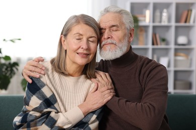 Photo of Cute elderly couple on sofa at home