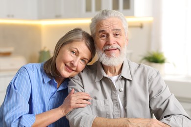 Portrait of happy elderly couple at home