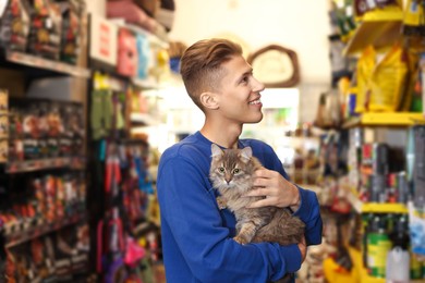 Man with his cute cat in pet shop