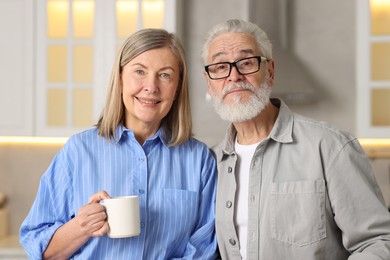 Photo of Portrait of happy elderly couple at home