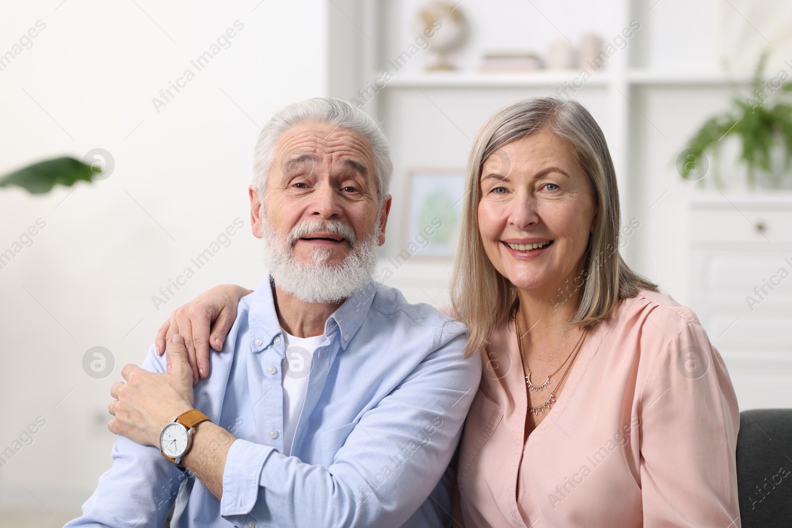 Photo of Portrait of happy elderly couple at home