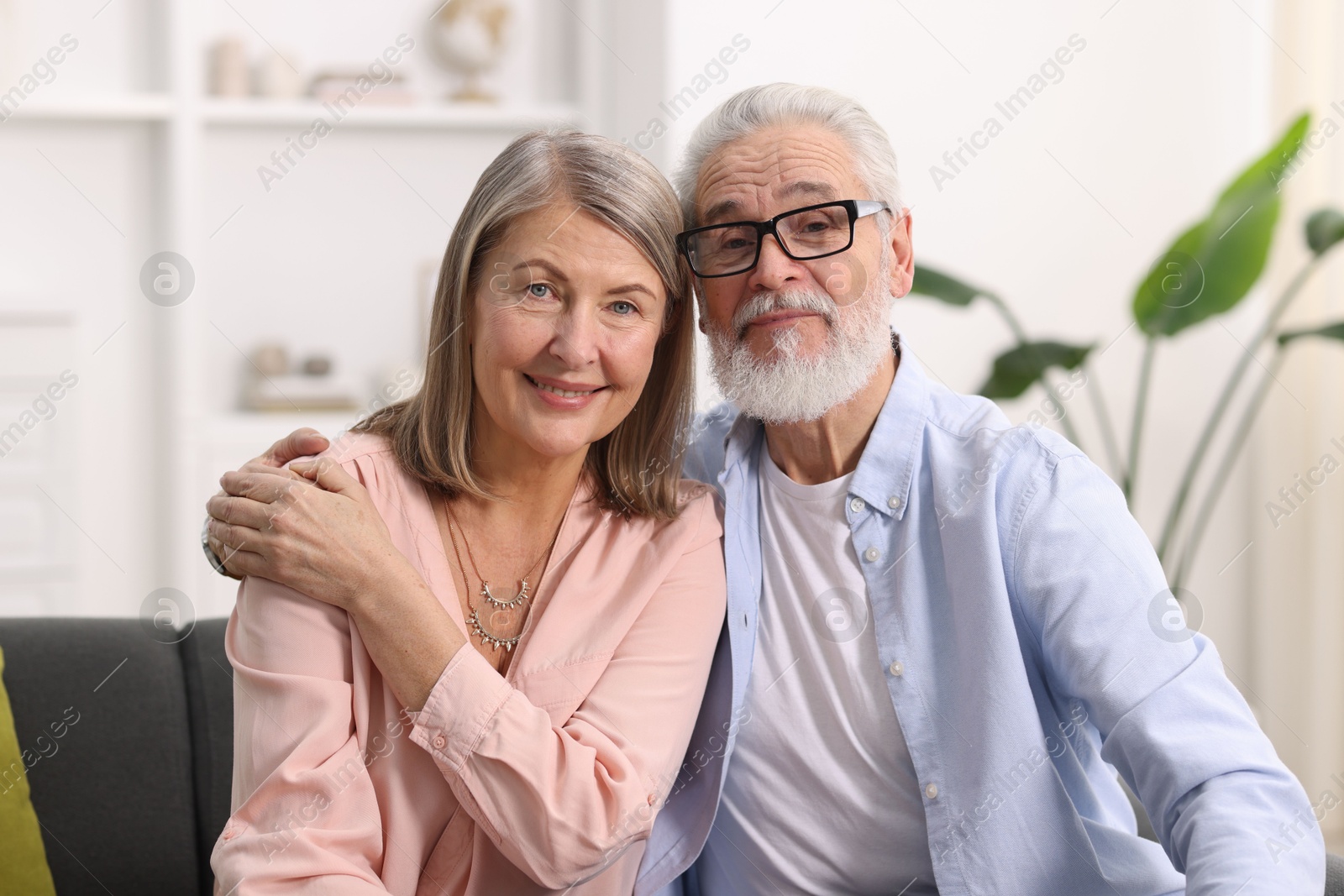 Photo of Portrait of happy elderly couple at home