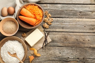 Photo of Different ingredients for making carrot cake on wooden table, flat lay. Space for text