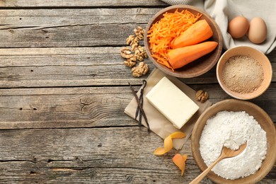 Photo of Different ingredients for making carrot cake on wooden table, flat lay. Space for text