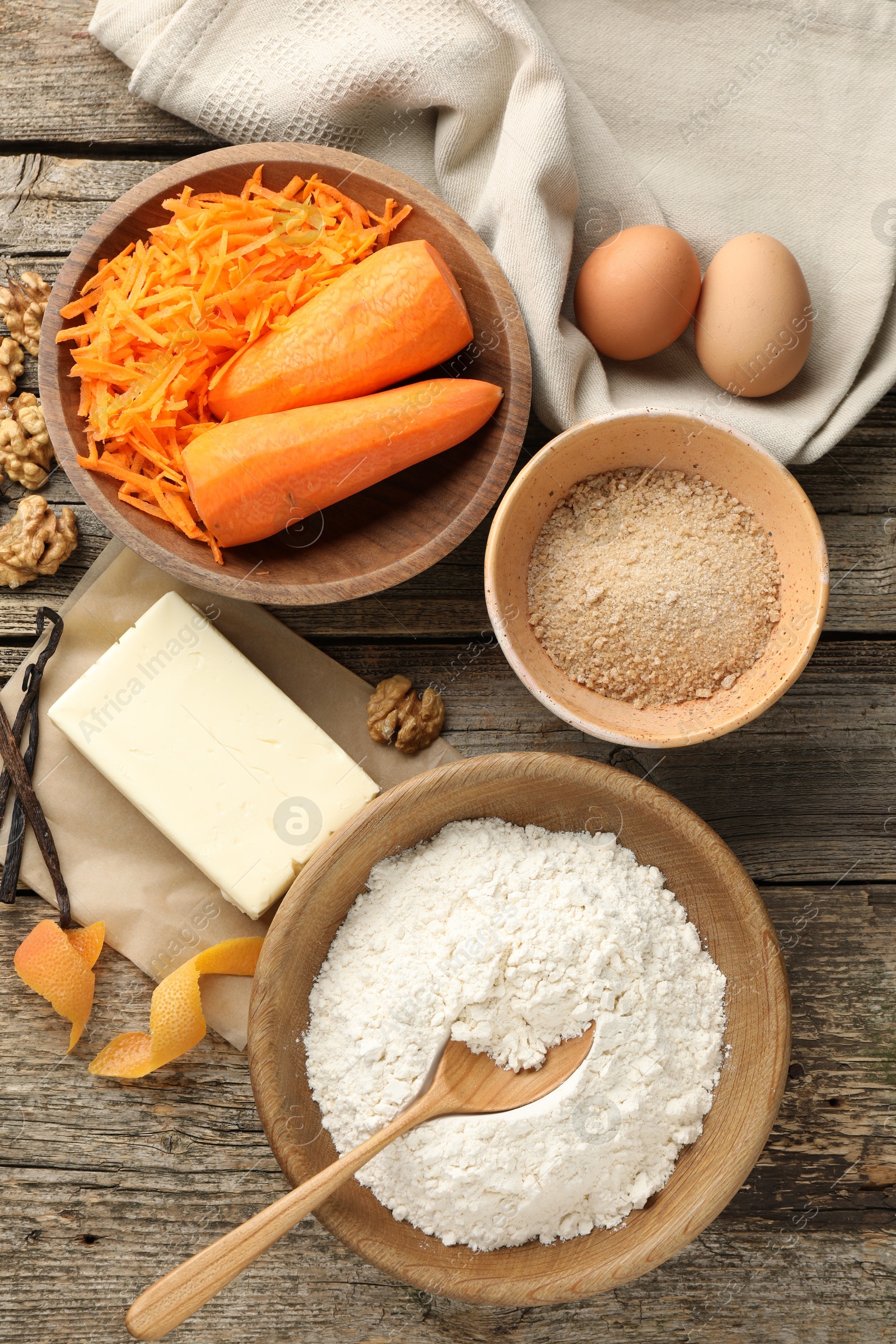 Photo of Different ingredients for making carrot cake on wooden table, flat lay