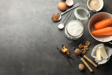 Photo of Different ingredients for making carrot cake and kitchenware on dark textured table, flat lay. Space for text