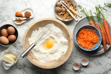 Photo of Making carrot cake. Different ingredients for dough and kitchenware on white marble table, flat lay