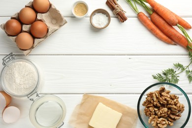 Photo of Frame of different ingredients for making carrot cake on white wooden table, flat lay. Space for text