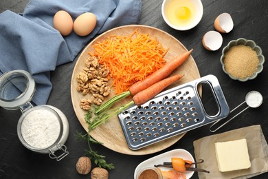 Photo of Different ingredients for making carrot cake on black table, flat lay