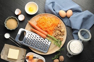 Photo of Different ingredients for making carrot cake on black table, flat lay