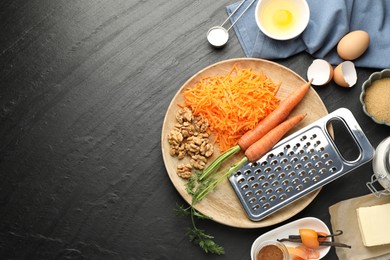 Photo of Different ingredients for making carrot cake on black table, flat lay. Space for text