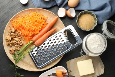 Photo of Different ingredients for making carrot cake on black table, flat lay