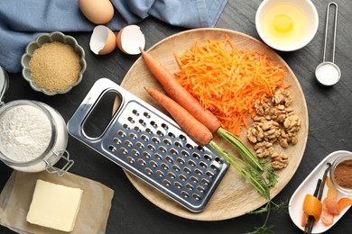 Photo of Different ingredients for making carrot cake on black table, flat lay