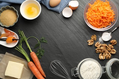 Photo of Frame of different ingredients for making carrot cake on black table, flat lay. Space for text