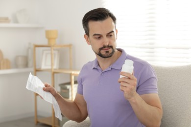 Photo of Man with pills and medical instruction at home