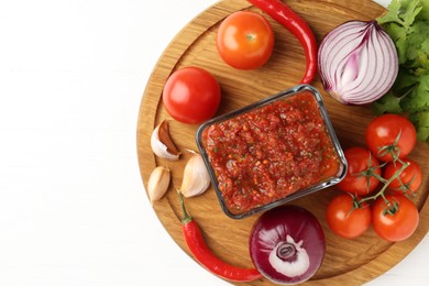 Photo of Delicious salsa sauce and ingredients on white wooden table, top view. Space for text