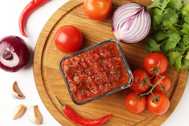 Photo of Delicious salsa sauce and ingredients on white wooden table, flat lay